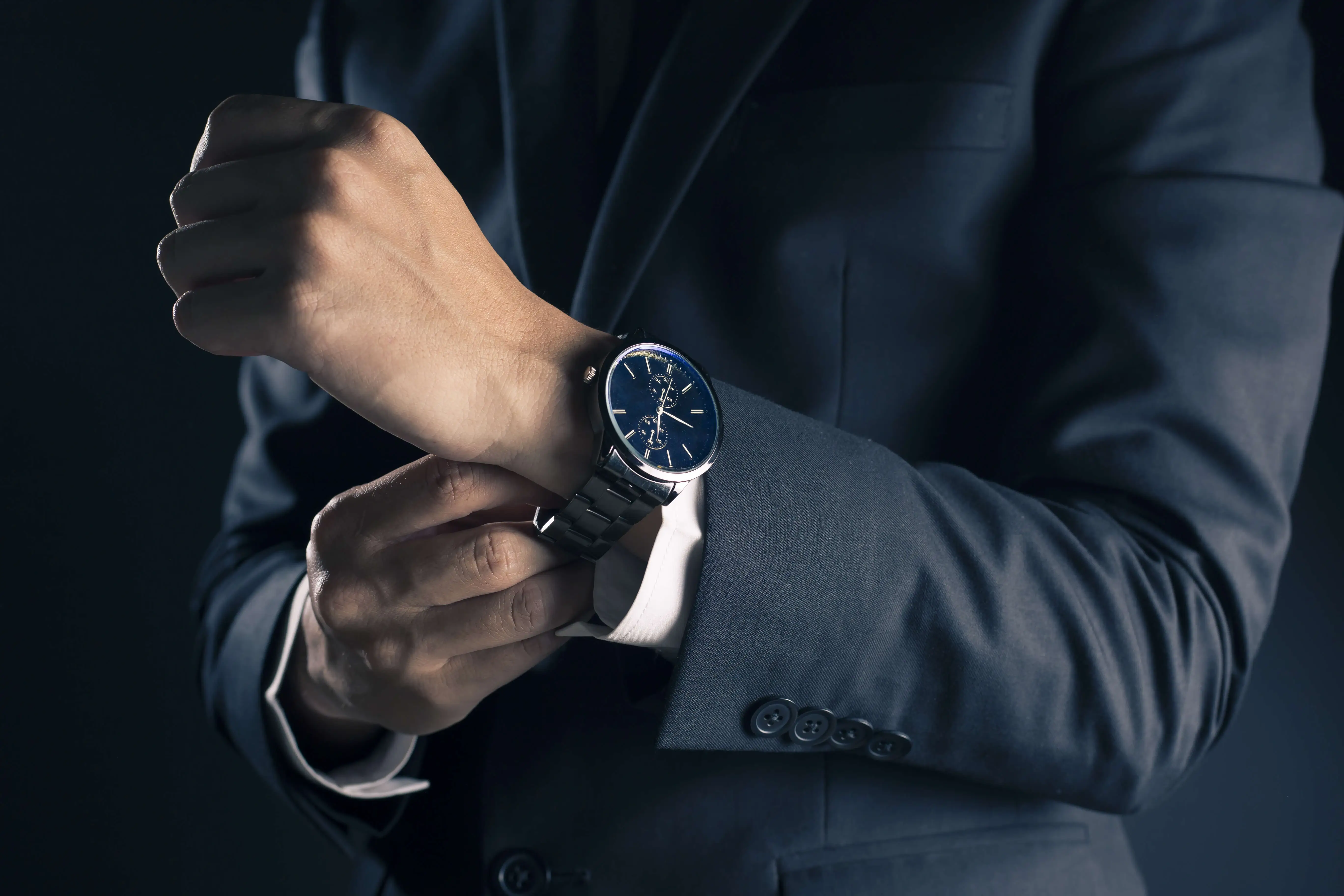 Close up of a watch on a wrist during a business meeting.